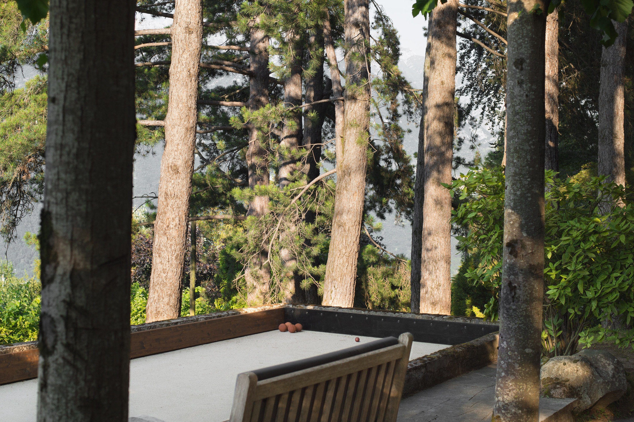 Traditional bocce court among the pines with lake view