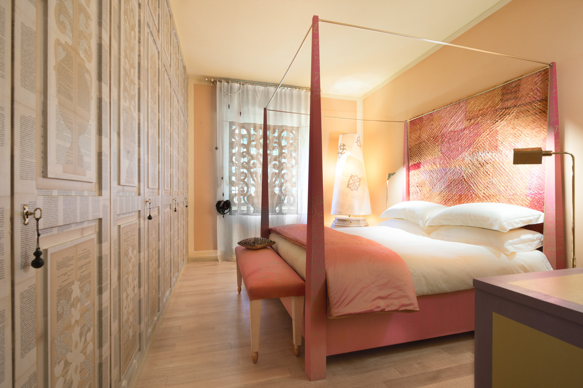 Bedroom with canopy bed and textured headboard