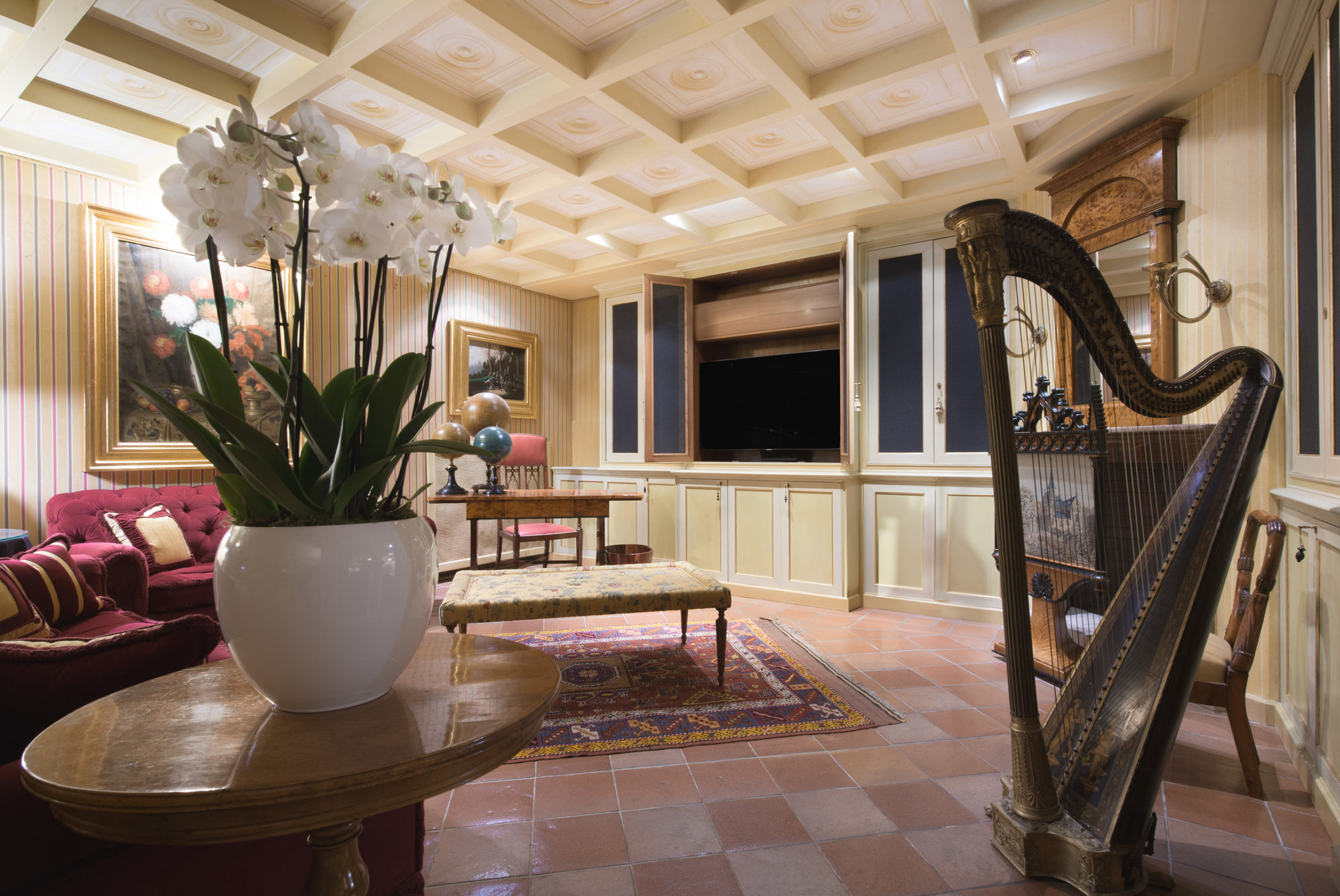 Sitting room with harp and coffered ceiling