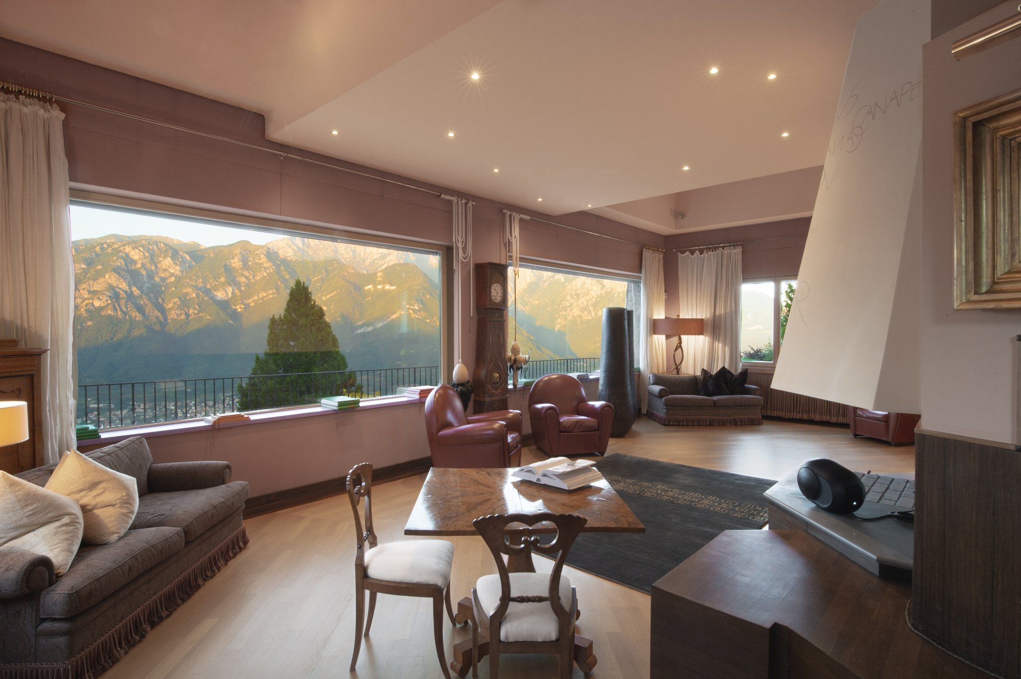 The grand salon at dusk, mountains through the picture windows