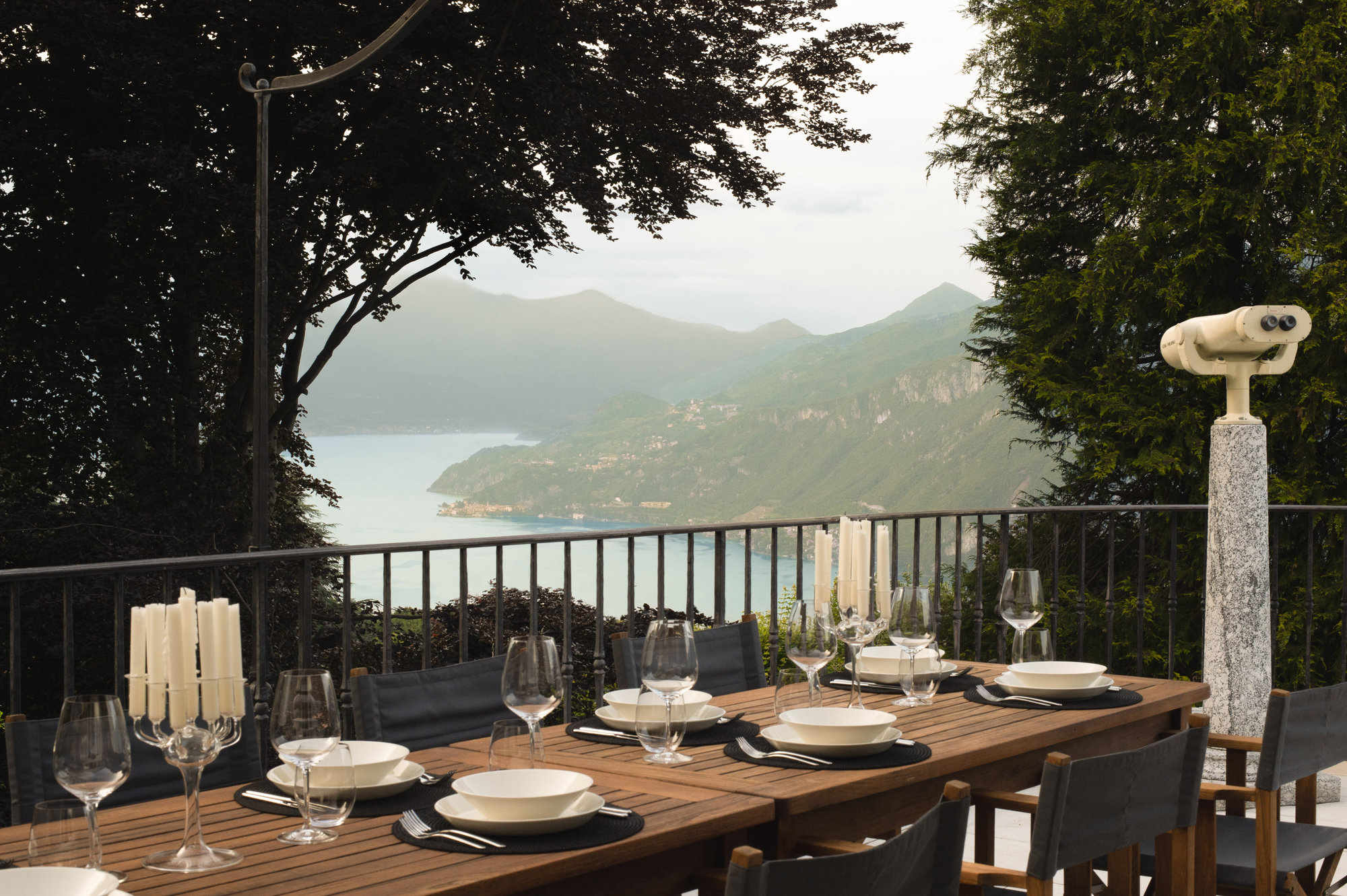 Outdoor dining table with telescope and lake view