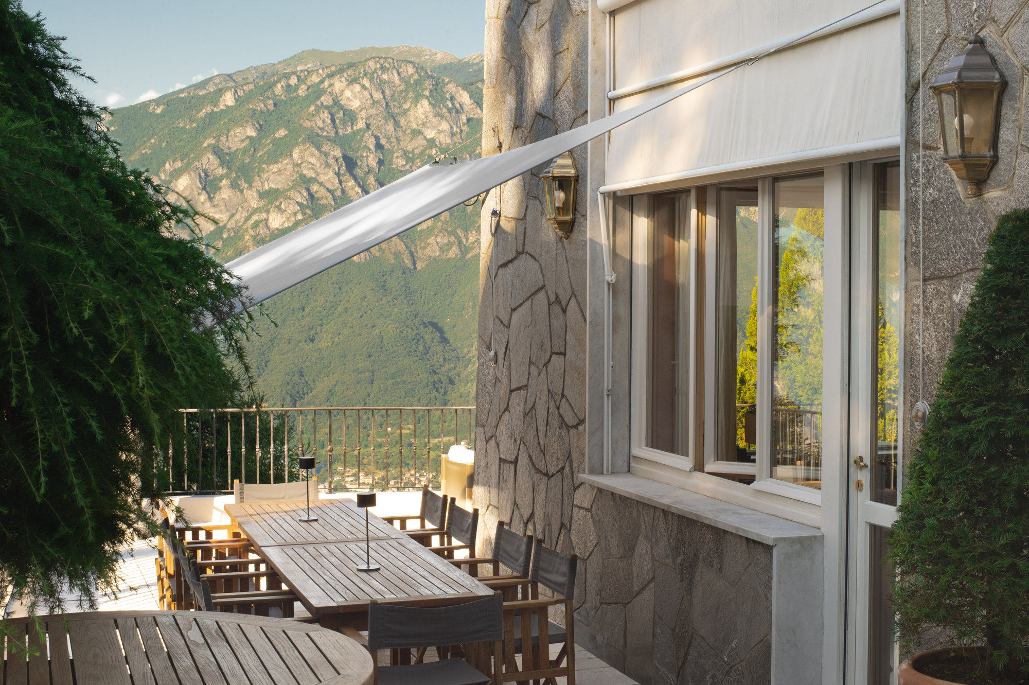 Terrace dining table with awning and mountain view